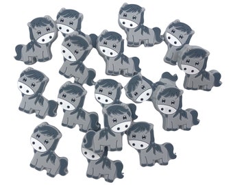 May include: A collection of gray horse-shaped silicone charms. The charms are small and have a cartoon-like design.