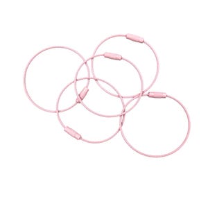 May include: Five pink keychains with a circular design. Each keychain has a metal cable loop with a pink clasp. The keychains are arranged in a slightly overlapping pattern against a white background.