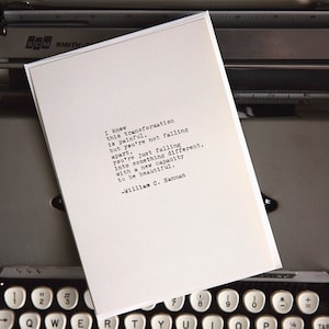 May include: A white card with black text on a typewriter. The text reads: "I knew this transformation is painful, but you're not falling apart. You're just falling into something different, with a new capacity to be beautiful. -William C. Hannan"