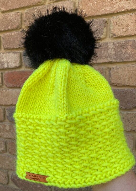 yellow hat with pom pom