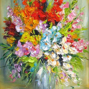 May include: A colorful bouquet of flowers in a blue vase. The flowers are a mix of pink, white, yellow, orange, and red.