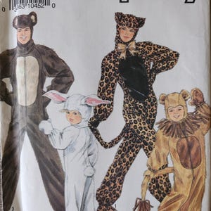 May include: A Simplicity sewing pattern envelope 9510 featuring illustrations of four costumes: a dark brown bear, a white rabbit with long ears, a leopard print jumpsuit with a black chest panel, and a tan bear with a ruffled collar and tail.