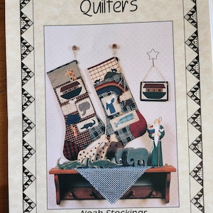 May include: A vintage sewing pattern for Noah's Ark themed Christmas stockings. The pattern is titled "Noah Stockings #9535" and features a colorful illustration of two stockings, a small ark, and a wooden figure of a shepherd.