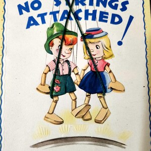 May include: A vintage birthday card with a whimsical illustration of two puppets with the text "No Strings Attached!" and the greeting "To This Birthday Wish - "