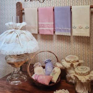 May include: A booklet titled "Mini Candlewicking Designs" by Country Crafts. Pat Walters. Leaflet No. PW. The booklet features images of various embroidery projects, including towels, sachets, and jar covers.