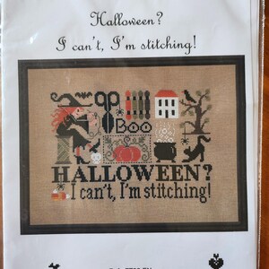 May include: A cross-stitch pattern kit with the text "Jardin Privé" and "Halloween? I can't, I'm stitching!". The design includes a witch, pumpkin, black cat, and other Halloween-themed elements. The kit is designed by Nathalie Cichon.