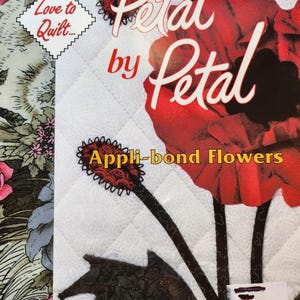 May include: A book titled "Petal by Petal" with a red flower on the cover. The book is about appli-bond flowers and is written by Joan Shay. The book cover has a white background with a quilted pattern.