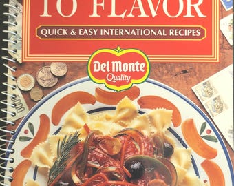 May include: A cookbook titled "Passport to Flavor" with the text "Quick & Easy International Recipes." The cover features a plate of pasta with sauce and vegetables. The Del Monte logo is visible.