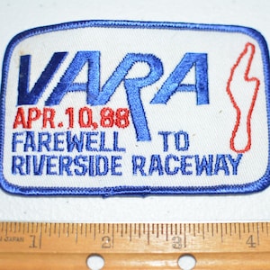 May include: A blue and red embroidered patch with the text "VARA APR. 10, 88 FAREWELL TO RIVERSIDE RACEWAY" and a red outline of a racetrack.