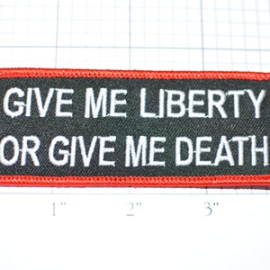 May include: A black and red embroidered patch with white text that reads "GIVE ME LIBERTY OR GIVE ME DEATH".
