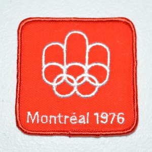 May include: Red embroidered patch with the Olympic rings and the text "Montréal 1976" in white.