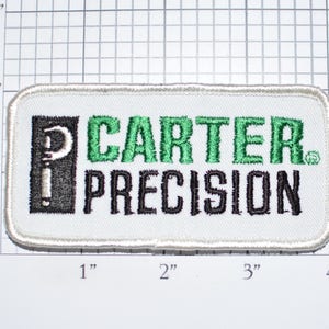 May include: White embroidered patch with black and green lettering. The patch reads "CARTER. PRECISION" with a stylized "P" in a black square.