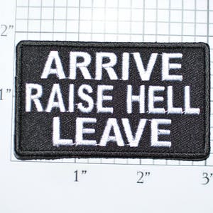 May include: Black embroidered patch with white text that reads "Arrive Raise Hell Leave".
