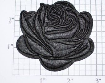 May include: Black embroidered rose patch, approximately 2 inches in diameter.