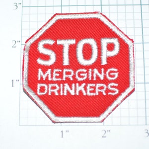 May include: A red stop sign patch with white stitching. The sign reads "STOP MERGING DRINKERS".