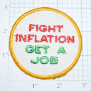 May include: A yellow, white, and green embroidered patch with the text "FIGHT INFLATION GET A JOB".