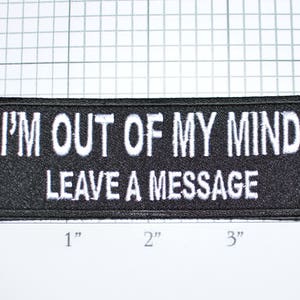 May include: Black embroidered patch with white text that reads "I'M OUT OF MY MIND LEAVE A MESSAGE".