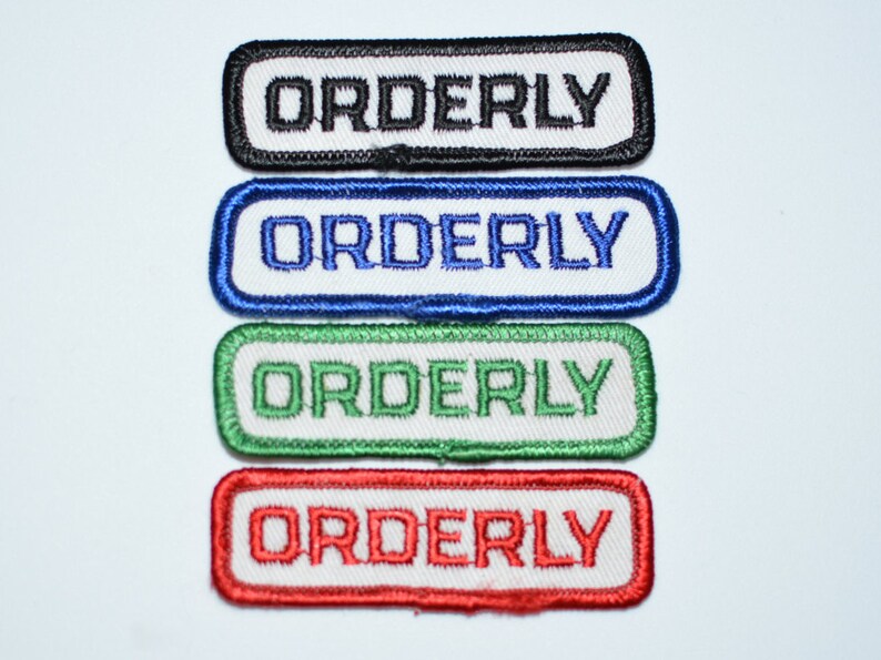 May include: Four embroidered patches with the word "ORDERLY" in white lettering on a black, blue, green, and red background.