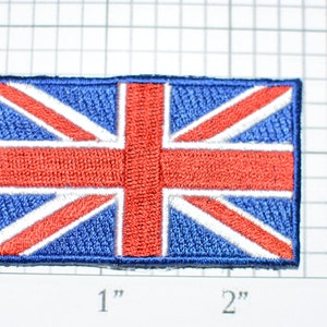May include: A blue and red embroidered patch of the Union Jack flag, approximately 1 inch by 2 inches.