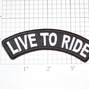 May include: Black and white embroidered patch with the text "LIVE TO RIDE" in a curved shape.