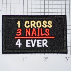 May include: Black embroidered patch with the text "1 CROSS 3 NAILS 4 EVER" in white, gold, and red thread.