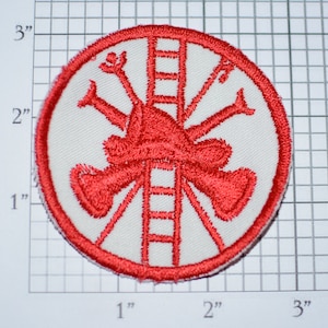May include: Red embroidered patch with a white background. The patch depicts a firefighter with a ladder and axes. The patch is approximately 2 inches in diameter.