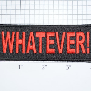 May include: A black embroidered patch with the word "WHATEVER!" in red lettering.