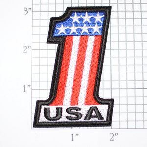 May include: A red, white, and blue embroidered patch shaped like the number one with the word "USA" at the bottom. The patch is approximately 2 inches tall and 1 inch wide.