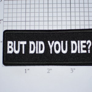 May include: Black embroidered patch with white text that reads "BUT DID YOU DIE?" The patch is approximately 3 inches wide and 1 inch tall.