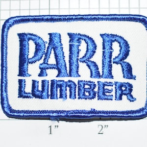 May include: Blue embroidered patch with white background. The patch reads "PARR LUMBER".