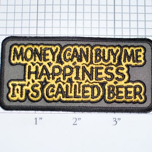 May include: A gray embroidered patch with black text that reads "Money can buy me happiness it's called beer".