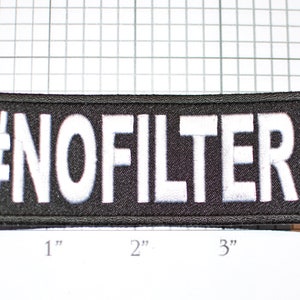 May include: Black embroidered patch with white text that reads "#NOFILTER" measuring approximately 3 inches wide and 1 inch tall.