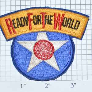 May include: A blue and white embroidered patch with a red star and a yellow banner that reads "READY FOR THE WORLD".