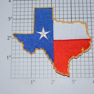 May include: Embroidered patch in the shape of the state of Texas. The patch features the Texas flag design, with a blue field and white star on the left, and white and red stripes on the right. The patch is approximately 3 inches wide.