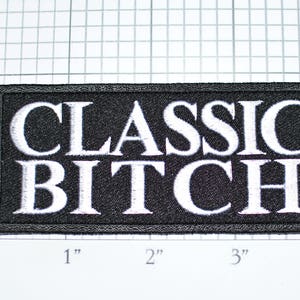 May include: Black embroidered patch with white text that reads "CLASSIC BITCH" measuring approximately 4 inches wide.