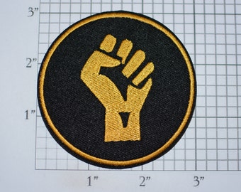 Raised Clenched Fist (Gold on Black) Iron-On Embroidered Patch Symbol of Solidarity Unity Strength Defiance Resistance for Jacket Vest Shirt