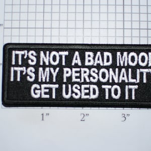 May include: Black embroidered patch with white text that reads "It's not a bad mood it's my personality get used to it".