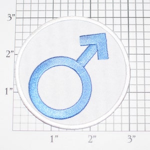 May include: A white embroidered patch with a blue male gender symbol. The patch is 2 inches in diameter.
