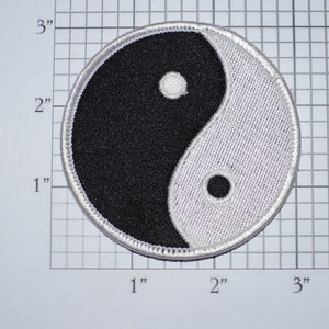 May include: A black and white yin yang symbol embroidered on a white fabric patch, measuring approximately 2.5 inches in diameter.