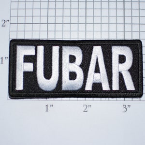 May include: A black patch with white embroidered letters spelling "FUBAR" on a white background. The patch is approximately 1 inch by 3 inches.