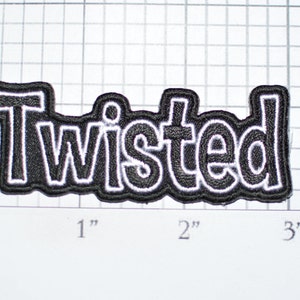 May include: Black and white embroidered patch with the word "Twisted" in a bold, outlined font.