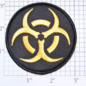 May include: A 2-inch diameter round black patch with a yellow biohazard symbol. The symbol is made of three interlocking loops.