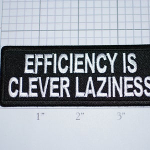 May include: Black embroidered patch with white text that reads "EFFICIENCY IS CLEVER LAZINESS".