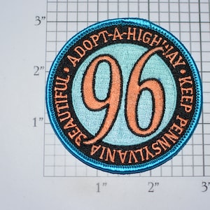 May include: A blue and black round patch with the text "Adopt-A-Highway Keep Pennsylvania Beautiful" surrounding the number "96" in orange.