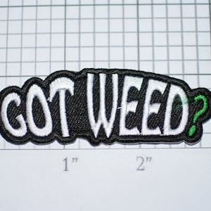 May include: Black and white embroidered patch with the text "GOT WEED?" in white with a green question mark.