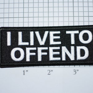 May include: Black and white embroidered patch with the text "I LIVE TO OFFEND" in white lettering on a black background.