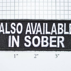 May include: Black embroidered patch with white text that reads "ALSO AVAILABLE IN SOBER".