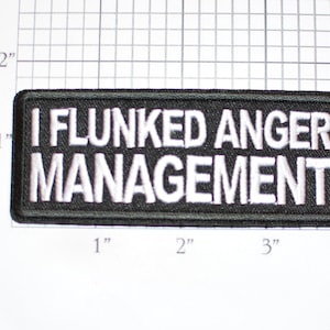 May include: Black embroidered patch with white text that reads "I Flunked Anger Management".