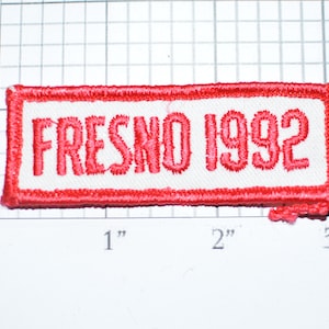 May include: Red embroidered patch with white lettering that reads "FRESNO 1992".
