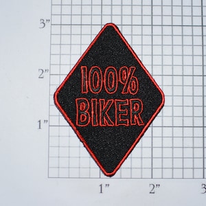 May include: Black diamond-shaped patch with a red outline. The patch says "100% BIKER" in red lettering.